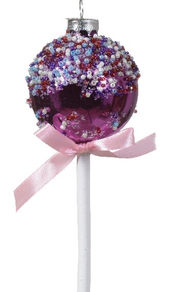 Στολίδι σε σχήμα cake pop χρώματος φούξια. Διακόσμηση με μωβ, γαλάζιες, κόκκινες και λευκές χάντρες. Στο λευκό ξυλάκι είναι δεμένος ένας ροζ φιόγκος.