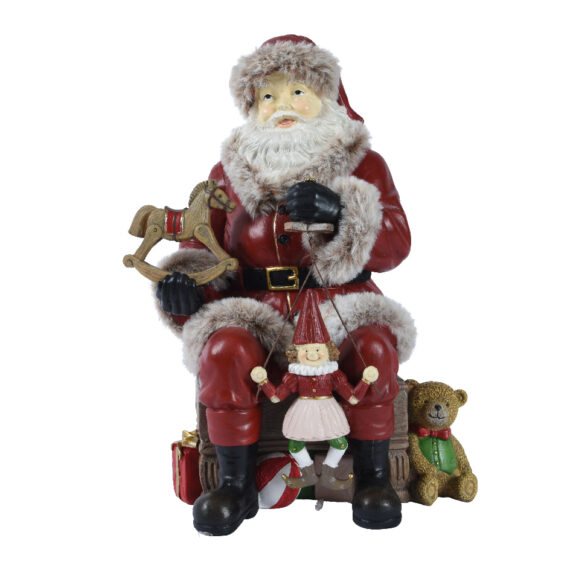 Αγαλματίδιο Άγιος Βασίλης  που κάθεται σε καρέκλα και κρατάει διάφορα παιχνίδια Κόκκινο 17 x 22,6 x 30cm
